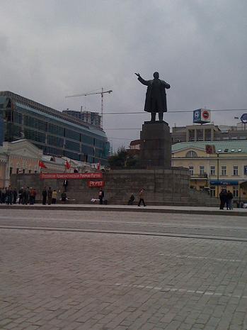 Statue of Lenin in Ekaterinburg, with red Communist flags and banners at the base