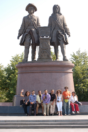 Visitors standing by a monument in Ekat