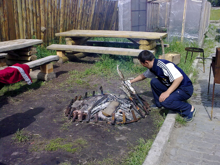 Cooking fish at a tourist camp near Lake Baikal